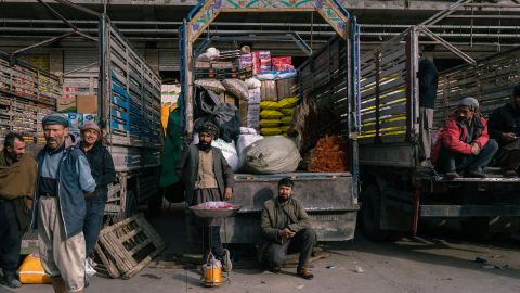 Männer vor Lastwagen mit Getreidesäcken und Lebensmitteln in Kabul