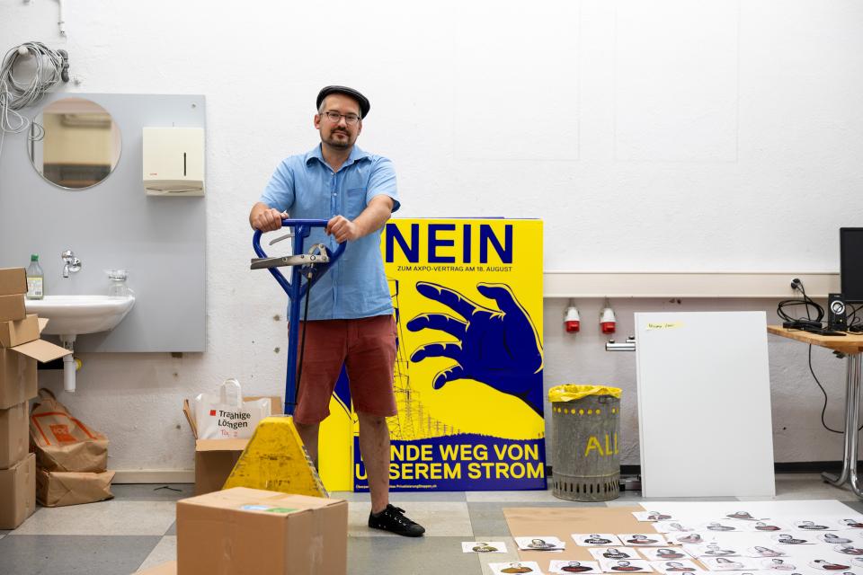 Matthias Frick steht vor einem Abstimmungs-Plakat