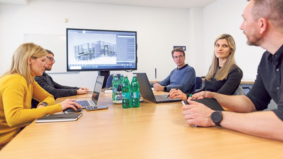 Mitarbeiter:innen der Techfirma Inea bei einer Besprechung